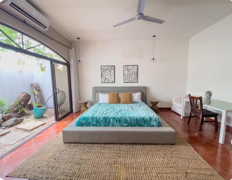 a bedroom with a bed and a large window at Hacienda La Luna Luxury Private Villa in Potrero