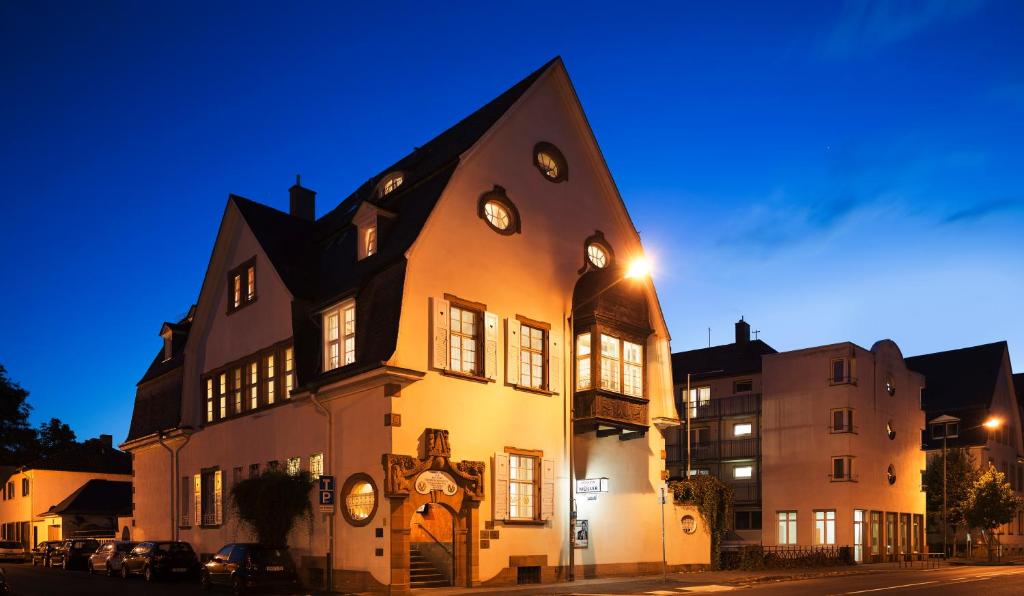 a building with a clock on the side of it at Hotel Haus Müller in Marburg an der Lahn