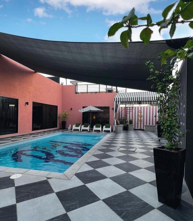 a swimming pool in a courtyard of a building at The Pink Pool - Swimming pool in Ras al Khaimah