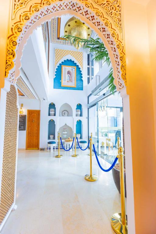 an archway in a building with blue and gold decorations at Moroccan Floors - Suites Appart-Hôtel in Tangier