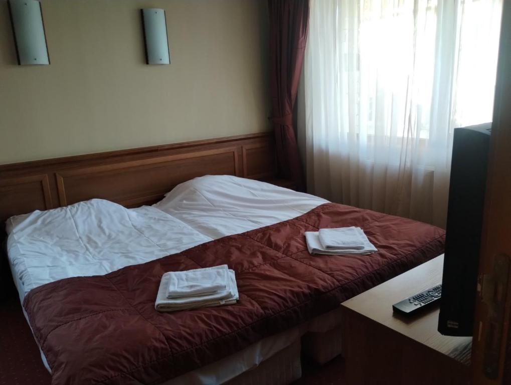 a room with a bed with two towels on it at hotel Sofia in Bansko