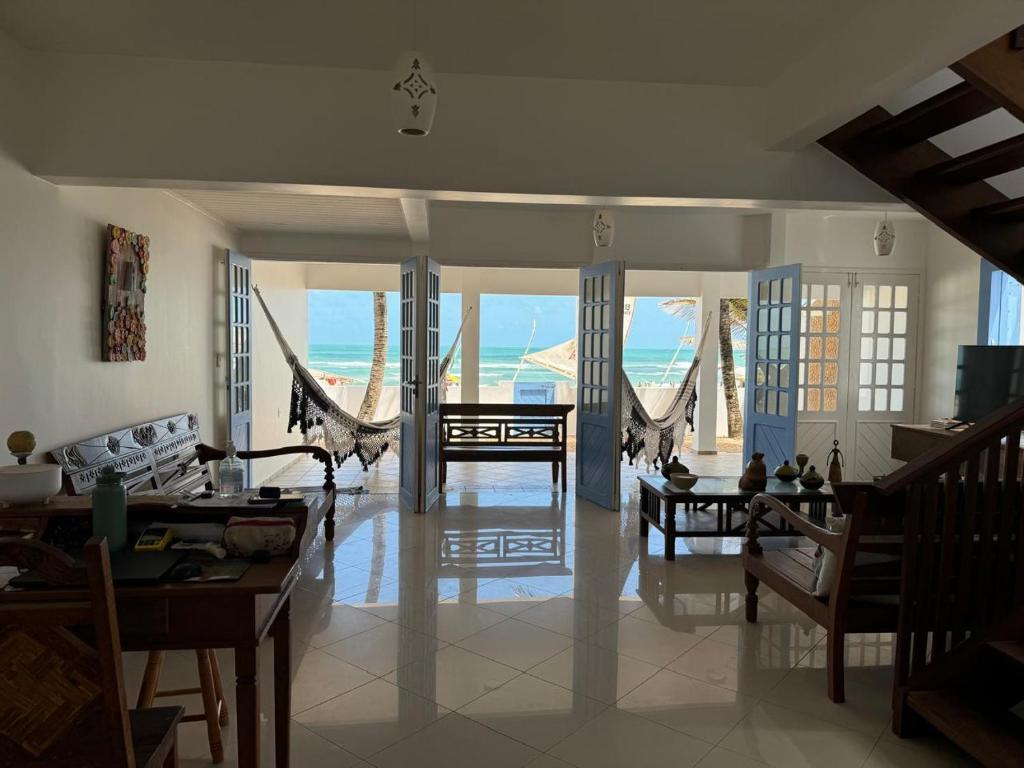 a living room with a view of the ocean at Pousada Caponga Praia Mar in Cascavel