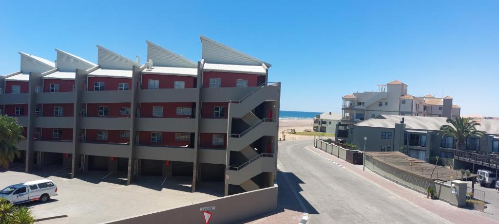 LangstrandPriai Longa 34 Self Catering的街道前有停车位的建筑物