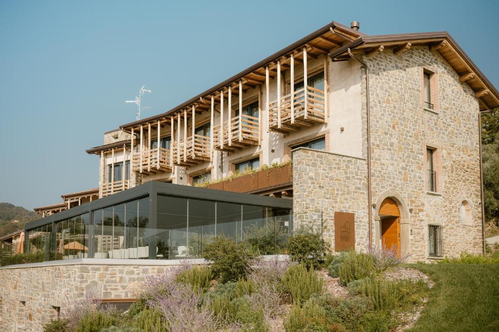 an external view of a building with a glass facade at Borgo Capietaglio Wine Resort in Gromlongo
