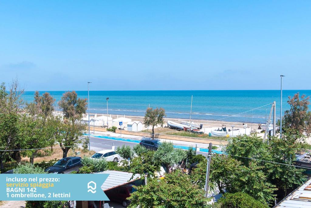 a view of a beach and the ocean at Appartamento a Senigallia sul mare - SE004 in Senigallia