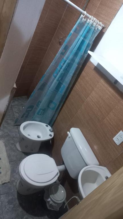 a bathroom with two toilets and a swimming pool at La morocha in Camba Punta