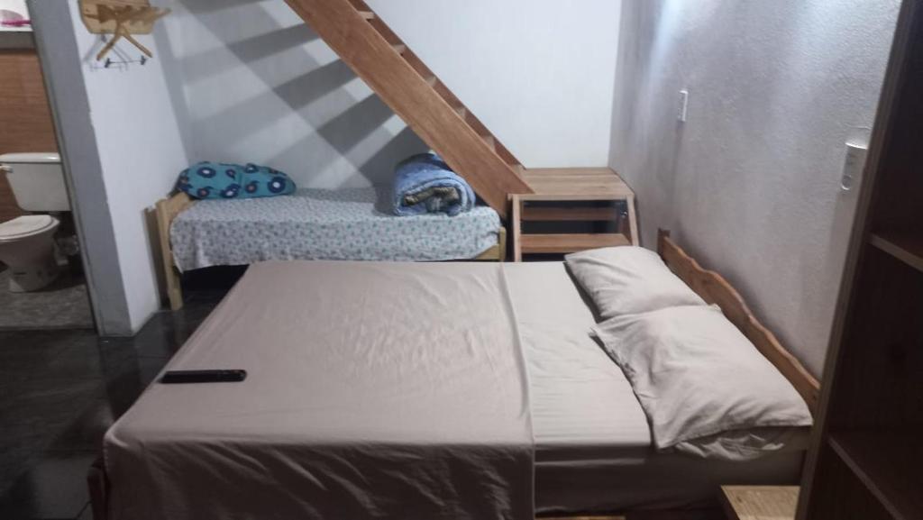 a small room with a bed and a staircase at La morocha in Camba Punta