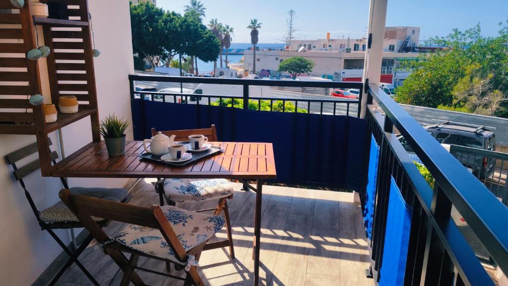 a table and chairs on a balcony with a view at Apartamento Rosamar, sea view in Los Cristianos