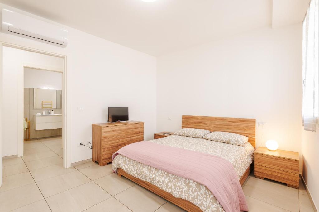 a bedroom with a bed and a television in it at FaCentro - Free WiFi & Air Conditioning in Faenza