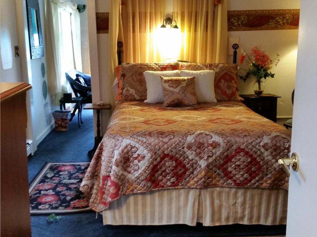 a bedroom with a bed with a quilt on it at 1 Murray House in Newport
