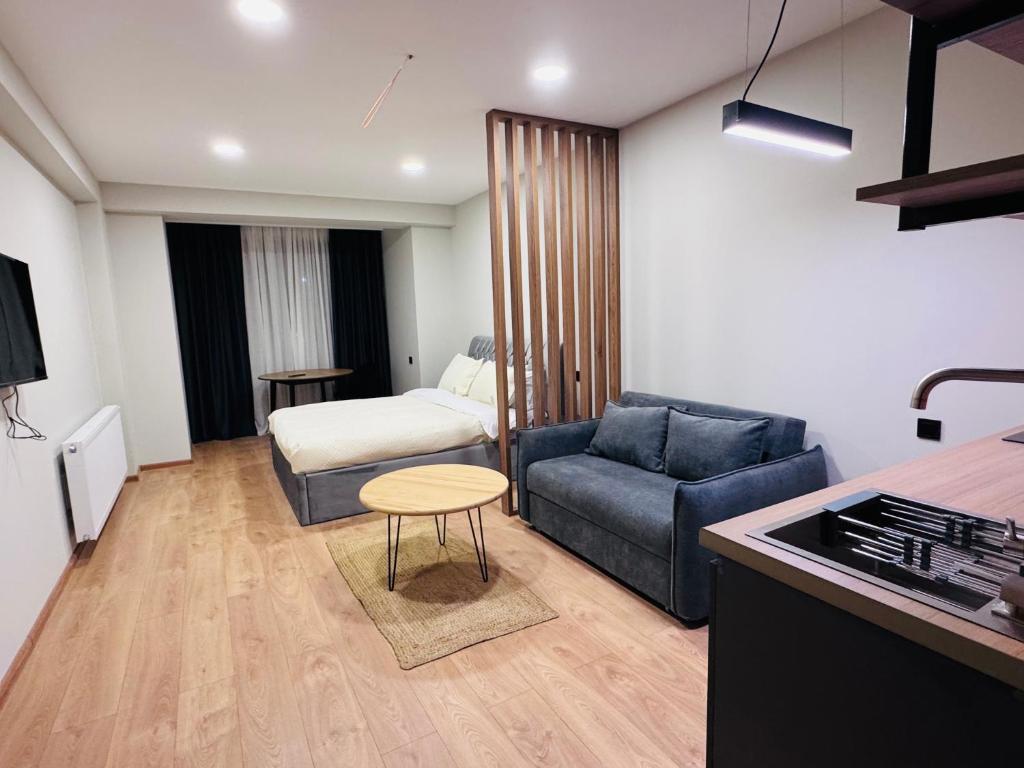 a small living room with a couch and a table at Skyheaven, new gudauri in Gudauri