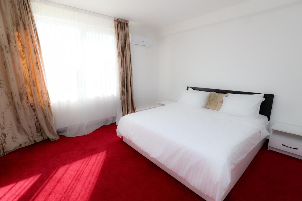 En eller flere senge i et værelse på Complex ALMA - Resort & SPA, Furnicoși