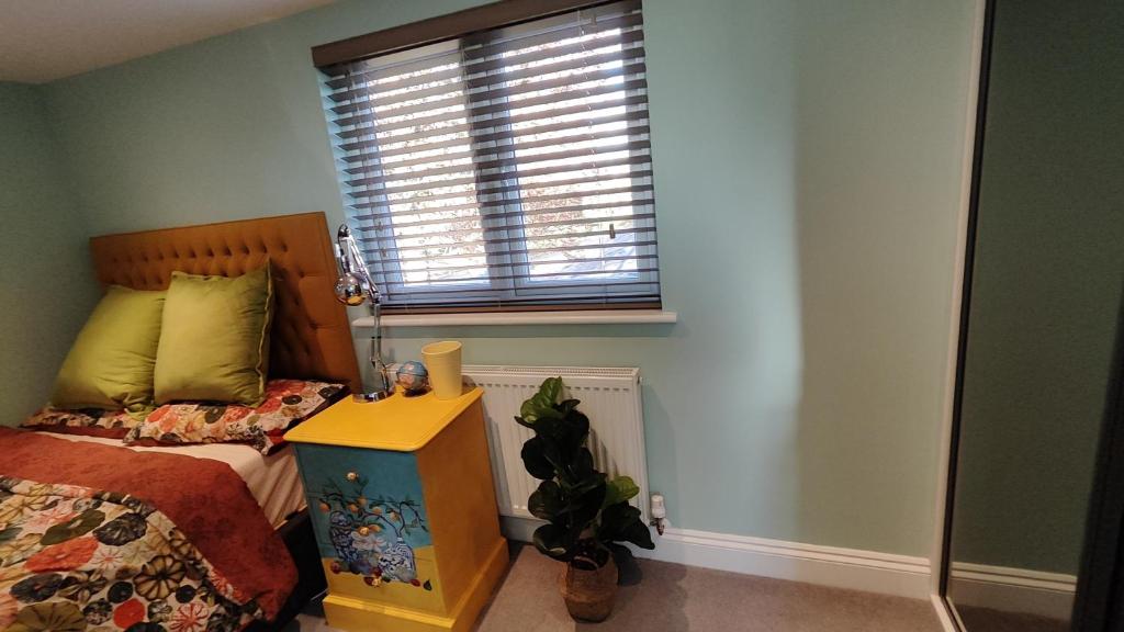 a bedroom with a bed and a window at Quiet Loft Double Room forty-five minutes by train to London Liv Street in Braintree