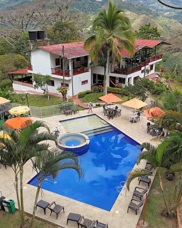an aerial view of a resort with a large swimming pool at Ecohotel Monteverde in La Vega