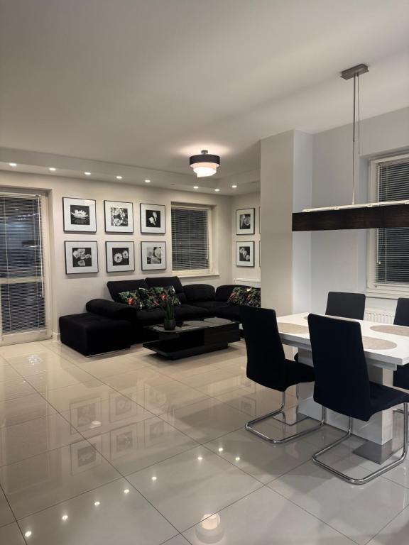 een woonkamer met een bank, een tafel en stoelen bij Spanko w centrum in Zielona Góra
