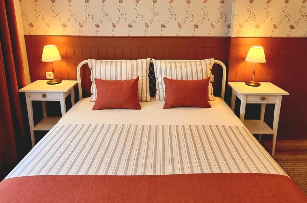 a bedroom with a bed with two tables and two lamps at 2 Bedroom Cozy Apartment in Antalya