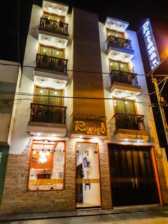 a facade of a hotel at night at Retama Hotel Tacna in Tacna