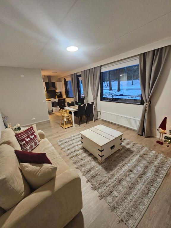 a living room with a couch and a large window at Studio Ski Lodge in Rovaniemi