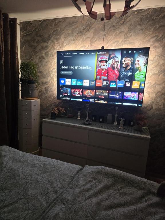a flat screen tv on a wall in a bedroom at schlafgut24 in Dortmund