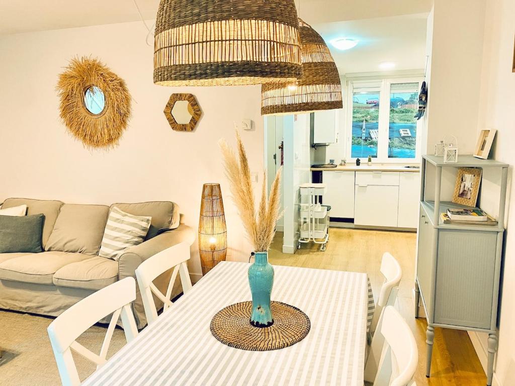 a living room with a table and a couch at Casa Branca Cantabria in Cuchia