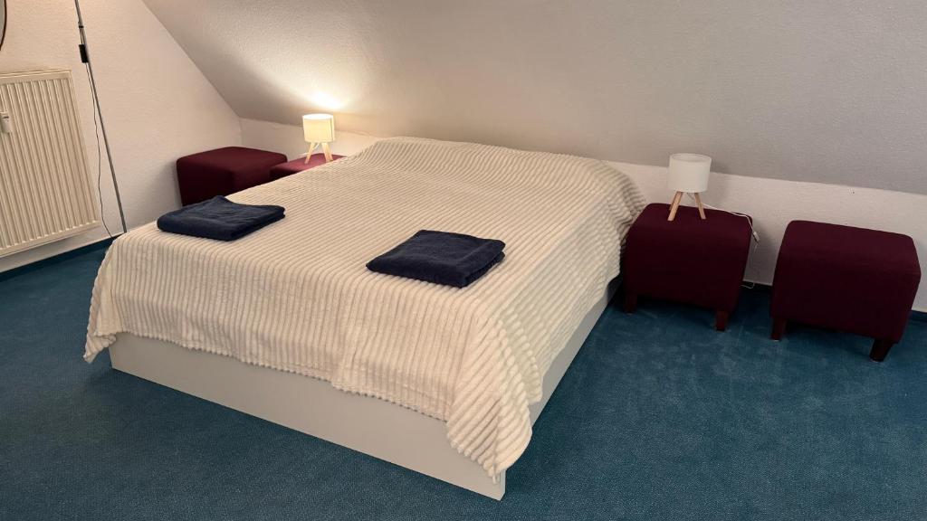a bedroom with a bed with two towels on it at Elbträume Lodge in Ellerhoop