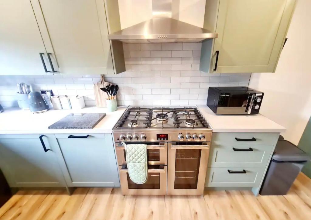 Urban 4BR house - Central-FREE parking-NO PARTY في غلاسكو: مطبخ صغير مع فرن علوي وموقد