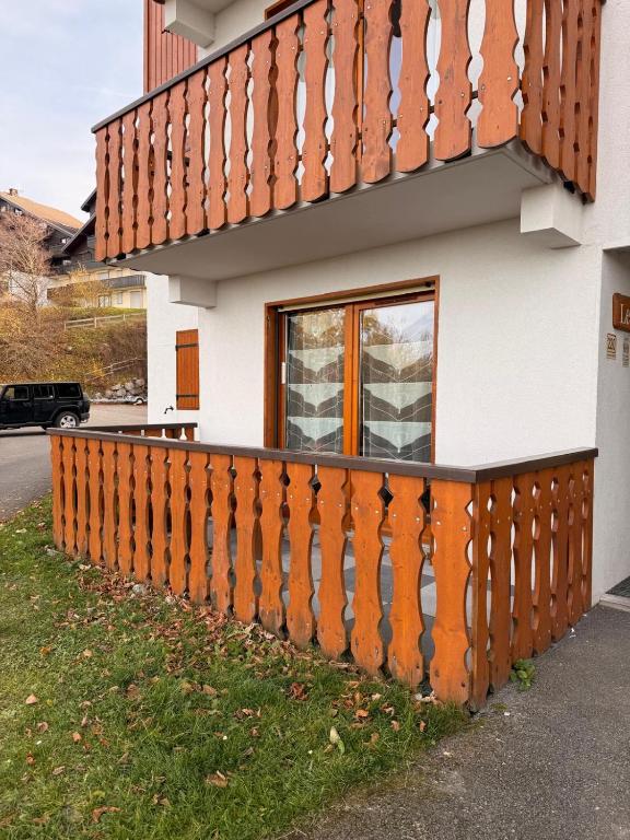 a house with an orange fence in front of it at apptT2 station ski familiale in Thollon