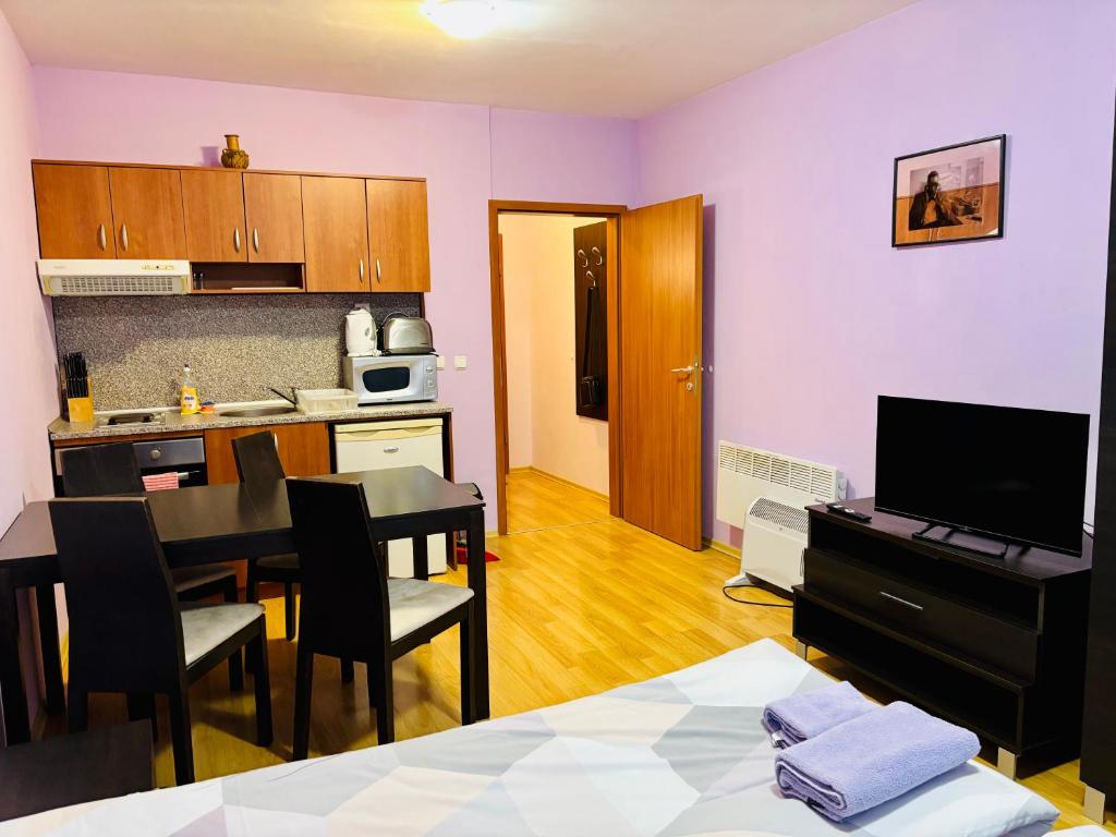 a living room with a kitchen and a dining room at Predela 1 - Studio 10 near Bansko Ski Lift in Bansko