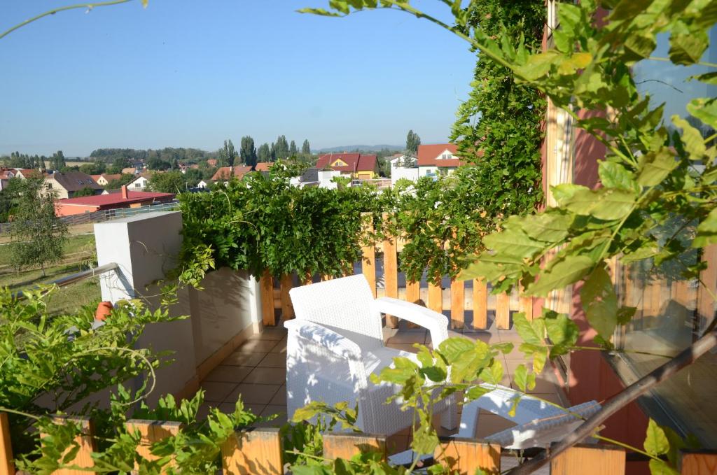 a white chair on the balcony of a building at Penzion Folbr in Dlouhá Lhota