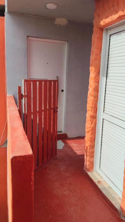an empty room with a red gate and a door at Positiva 3 in Mar de Ajó