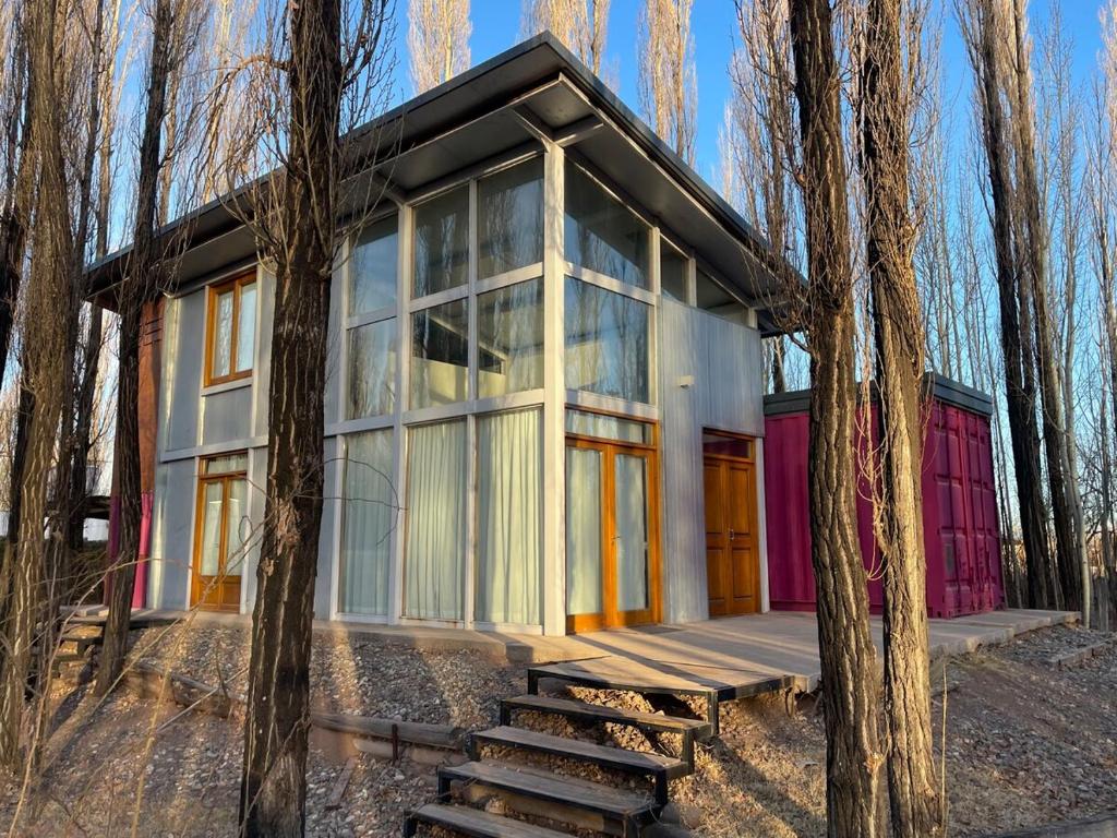 a small house in the woods with trees at Casa Sol de Enero in Malargüe