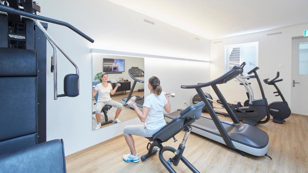 two women exercising on a treadmill in a gym at Hotel Wettstein in Basel