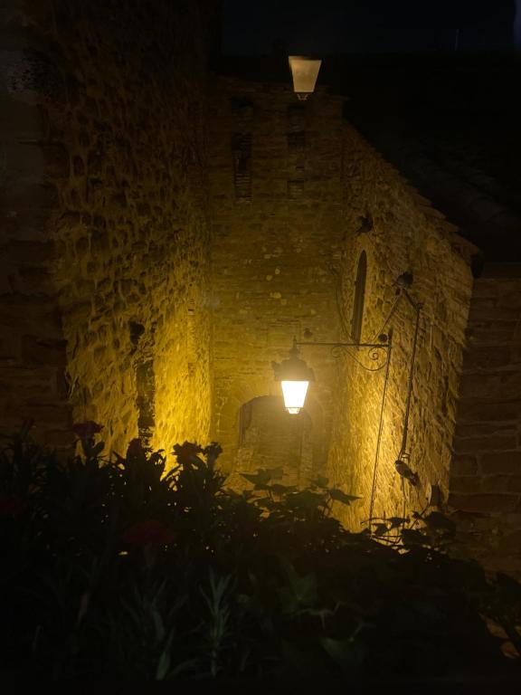 PetrignanoCasa al Castello的夜晚石墙上的一盏灯
