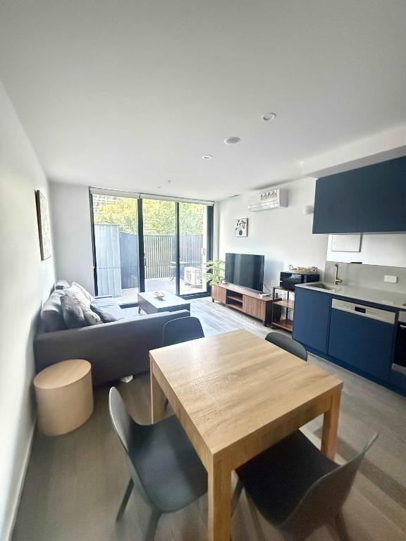 a living room with a table and a couch at CBD - Pool - Sleeps 4 - Parking in Canberra