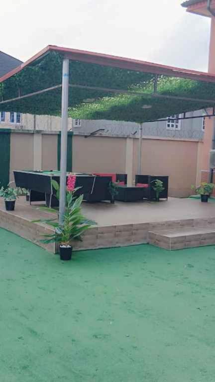 a pavilion with a table and chairs in a patio at Casamia in Ogba