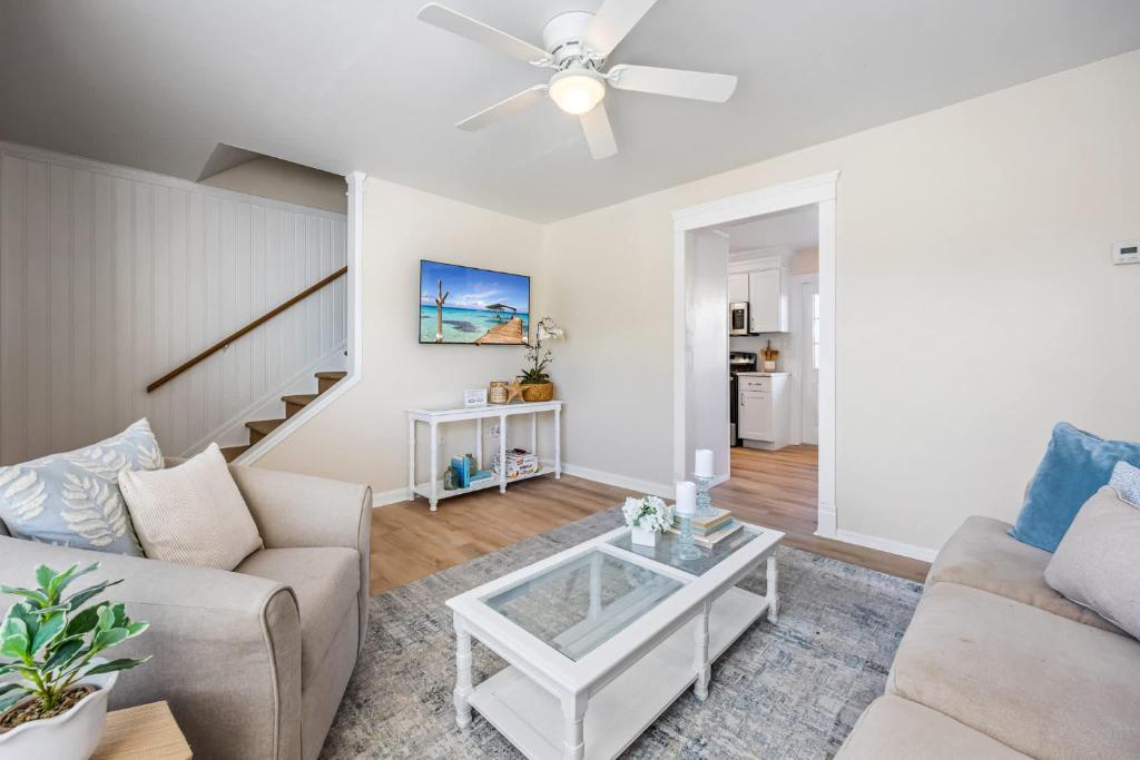 a living room with a couch and a table at Beachside Blast Off Stylish Cape Canaveral Townhome Near Surf & Space in Cape Canaveral