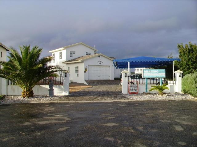 a house with a blue canopy in a driveway at Makarios B&B in Langebaan