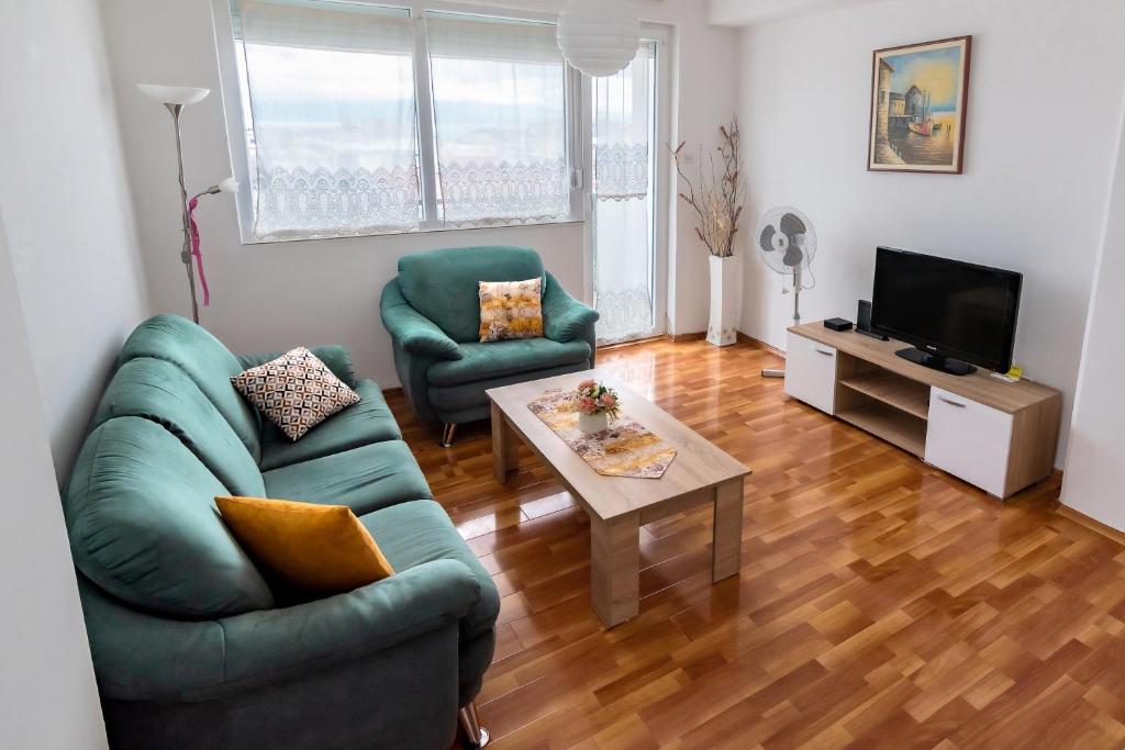 a living room with a couch and two chairs and a table at Charming & Spacious 2 Bedroom Apartment with a Gorgeous 8th-floor view in Ohrid