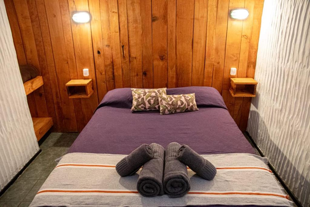 a bed with two stuffed animals laying on it at EcoHotelTDF in Río Grande