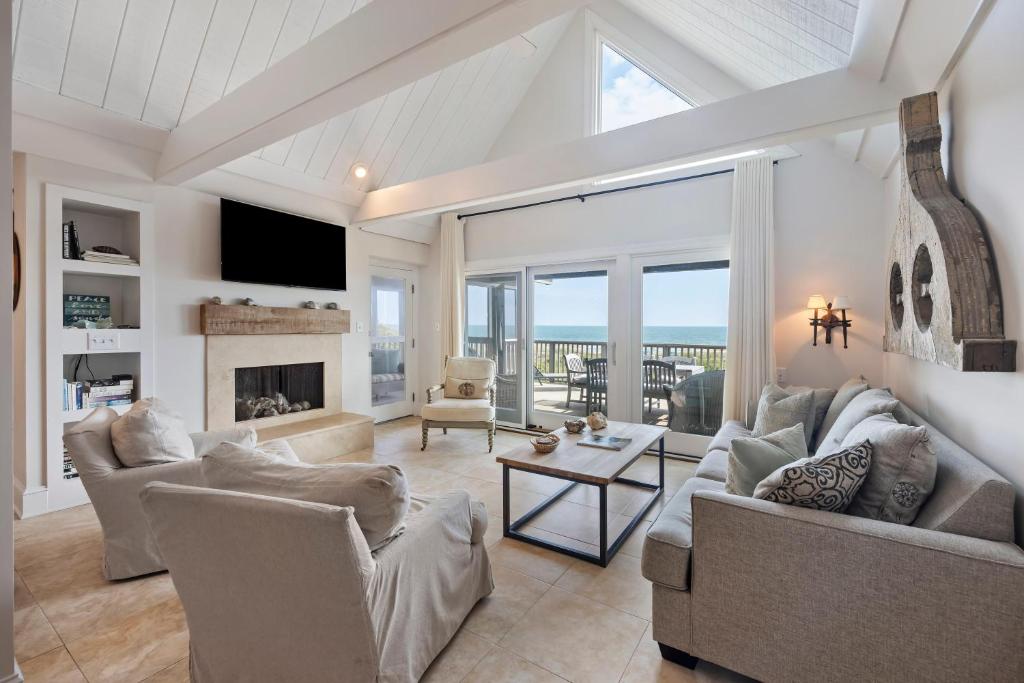 a living room with couches and a fireplace at SS3559: 3559 Seascape in Kiawah Island