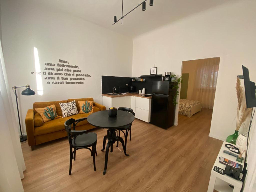 a living room with a table and a couch at AMA HOMe, moderno appartamento in centro con terrazzo privato vicino Economia e Porto in Ancona
