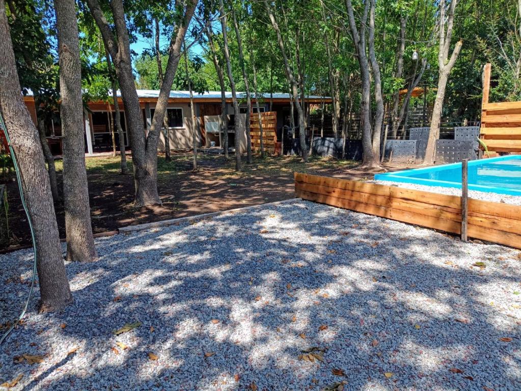 a swimming pool in a yard with trees at Tranqueras al Norte in Chascomús