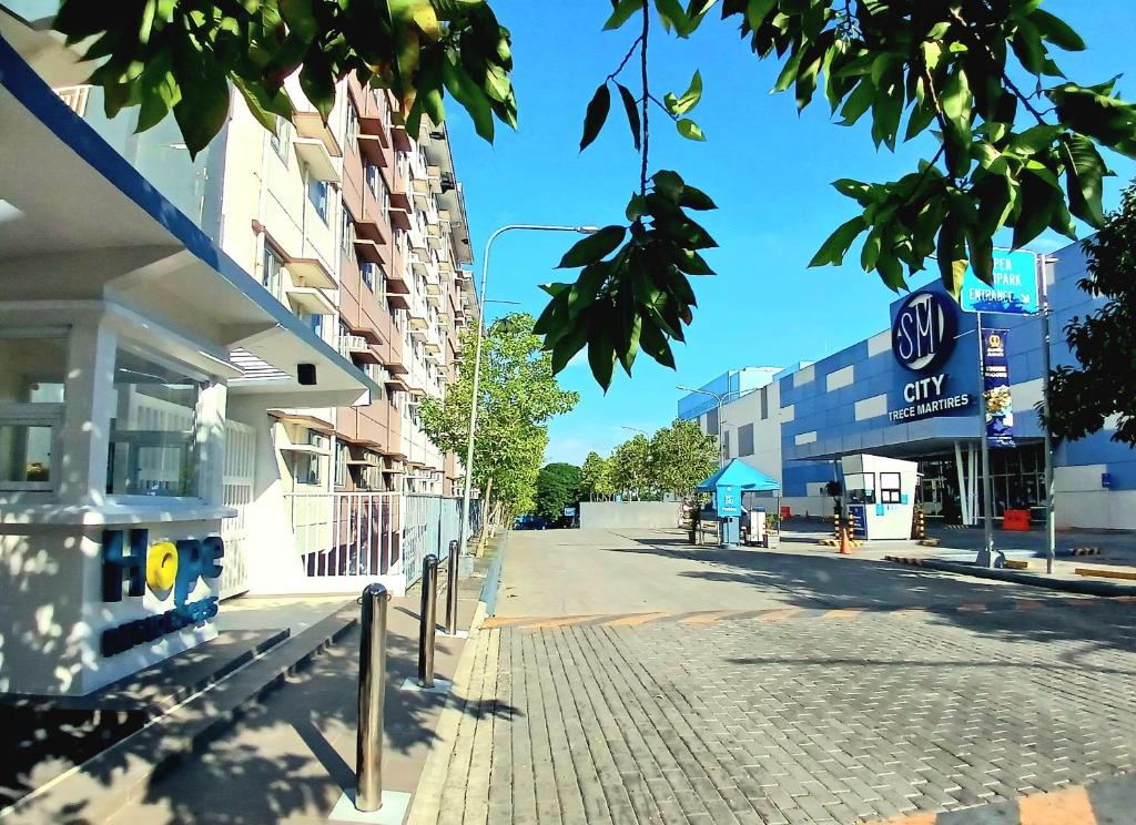 an empty street in a city with buildings at The Lumiére Stays Sophisticated Escape Mallside Charm in Trece Martires