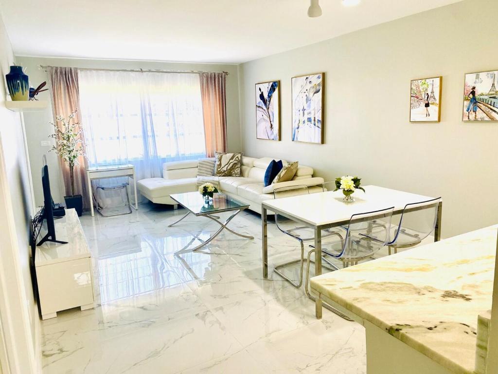 阿文图纳Stylish 1BR 2BA Condo 1Block to Aventura Mall的客厅里有一张沙发和一张桌子。