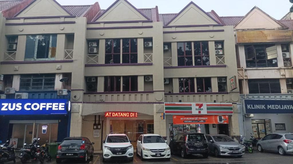 a large building with cars parked in front of it at iBilik Hotel - Sunway Lagoon, Petaling Jaya in Petaling Jaya