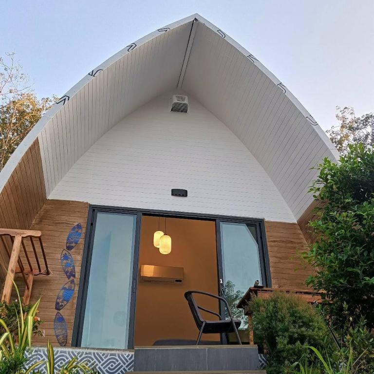 a chair sitting in front of a house at Castaway on Mook in Ko Mook