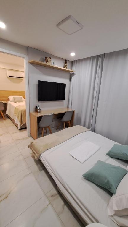 En eller flere senge i et værelse på Harbor Living - Flat no Centro, Piscina, Academia & Wi-Fi