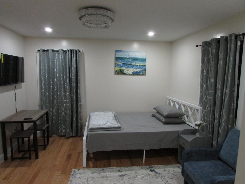 a small room with a bed and a couch at Cozy Rooms in Ozone Park in Brooklyn Manor