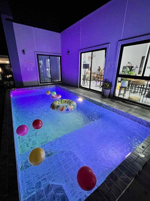 a large swimming pool with colorful balls in it at TwoEightsix 286 Poolvilla in Ban Khun Thale
