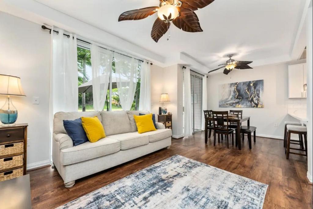 a living room with a couch and a dining room at Luxury Villa Paradise Home in Honokai Hale